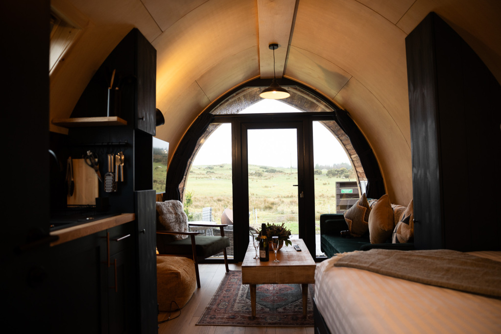 View through a pod’s arched doorway to open Galloway fields